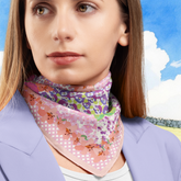 Woman wearing a colourful floral ditsy scarf with a scenic background